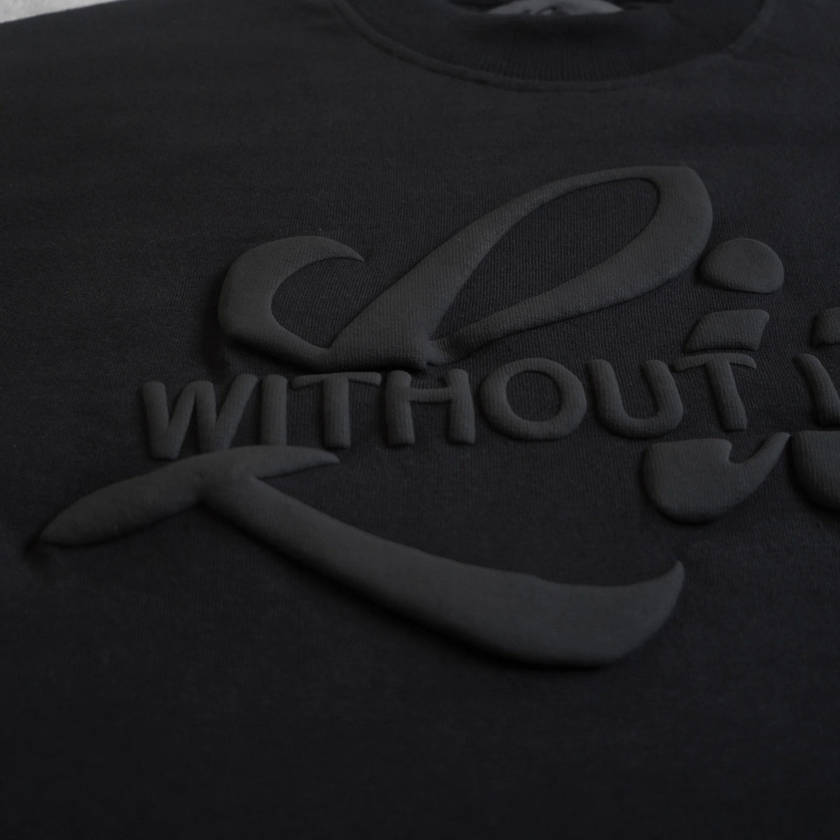 Black t-shirt with a logo and text on a black background
