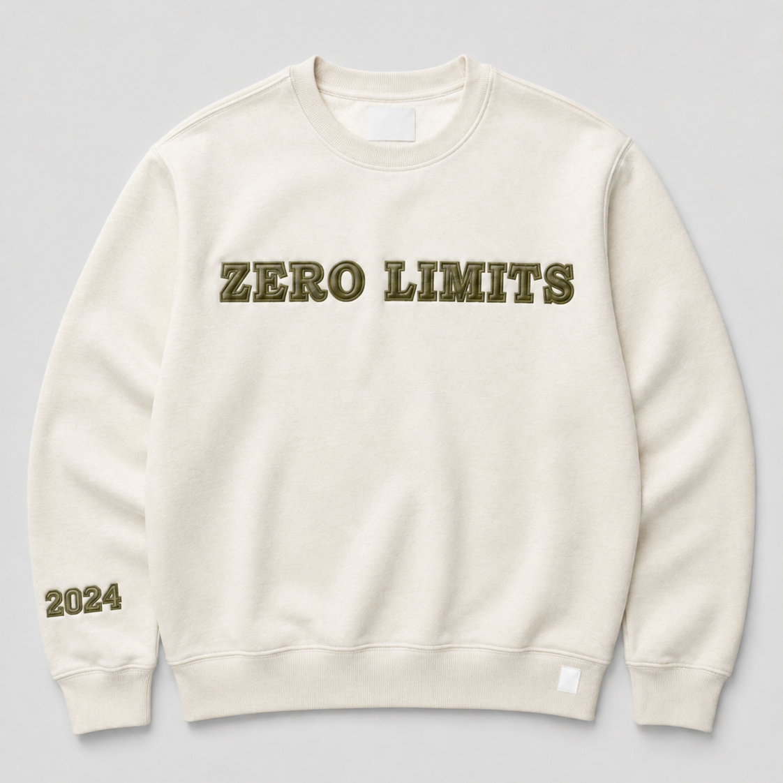 An off-white crewneck sweatshirt with 'ZERO LIMITS' printed across the chest in olive green block letters and '2024' printed on the left sleeve, shown against a neutral gray background.