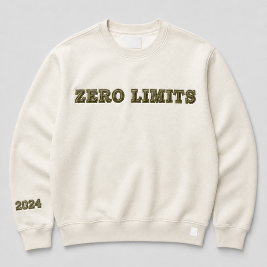 An off-white crewneck sweatshirt with 'ZERO LIMITS' printed across the chest in olive green block letters and '2024' printed on the left sleeve, shown against a neutral gray background.